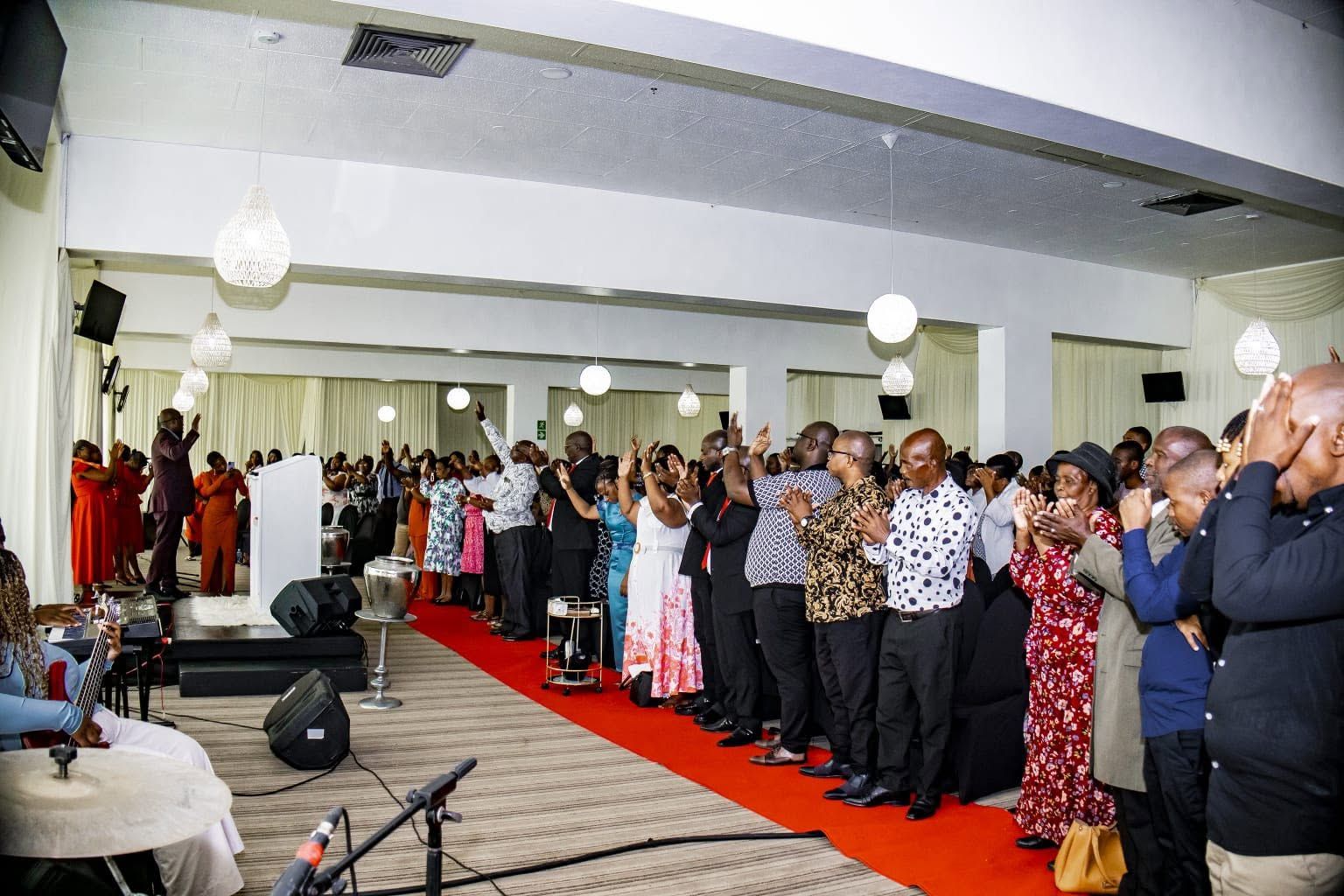 The congregation standing in worship during a Sunday service